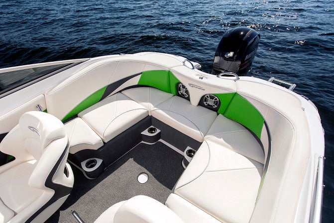 The main cockpit features a flowing, wrap-around U-shaped lounge that neatly integrates a pair of stereo speakers in the transom backrest.