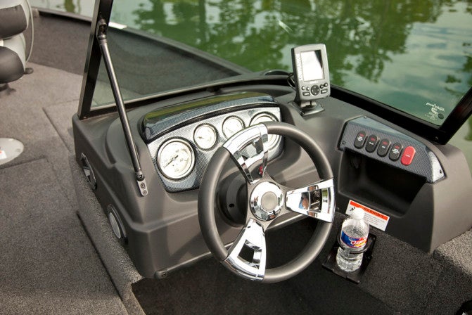 The neat and attractive helm console includes full gauges and a standard Lowrance Hook 3x fishfinder.